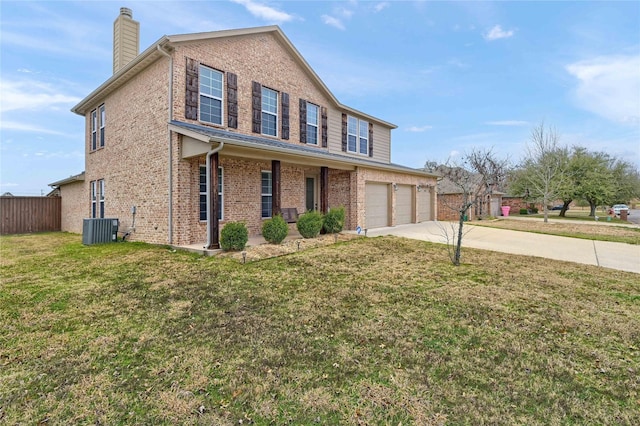 traditional-style home with a front yard, a chimney, concrete driveway, and brick siding