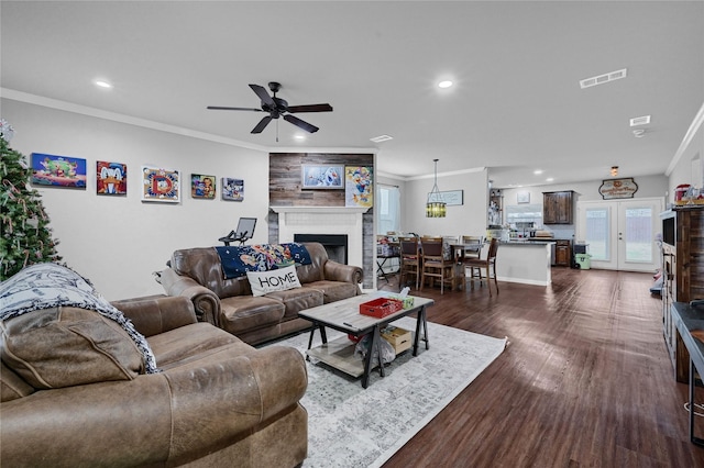 living area with ornamental molding, recessed lighting, dark wood-style flooring, and visible vents