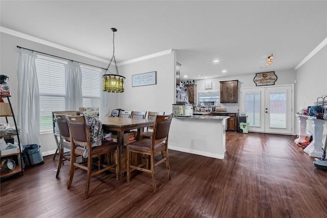 dining room with dark wood-style floors, french doors, a healthy amount of sunlight, and crown molding