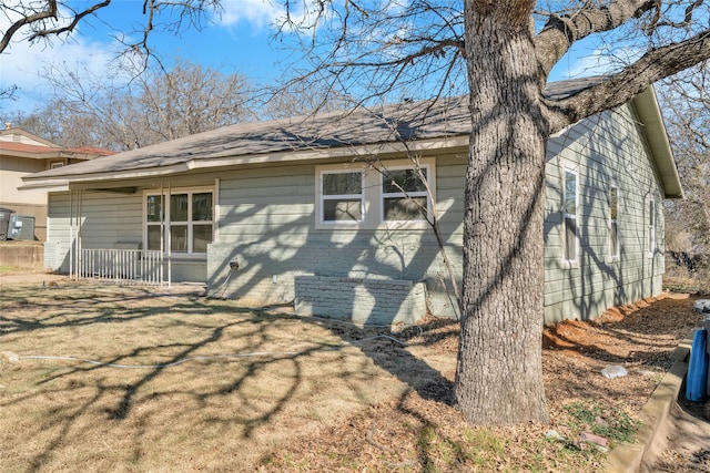 view of home's exterior with a lawn and brick siding