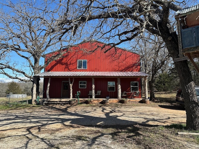 view of front of property featuring metal roof and a porch