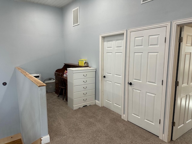 interior space featuring carpet floors and visible vents