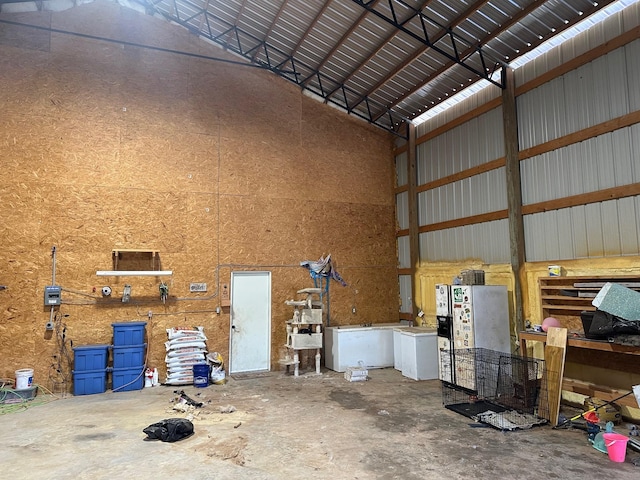 garage with a workshop area and metal wall