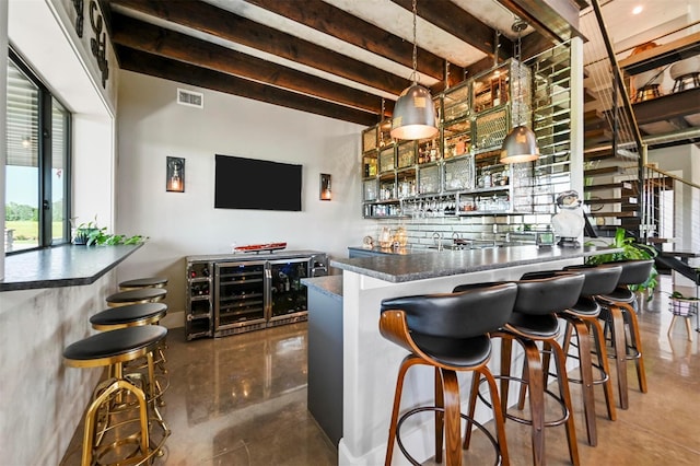 bar with a dry bar, visible vents, stairway, beamed ceiling, and pendant lighting