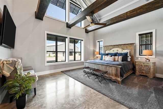 bedroom with a towering ceiling, a ceiling fan, baseboards, and concrete flooring