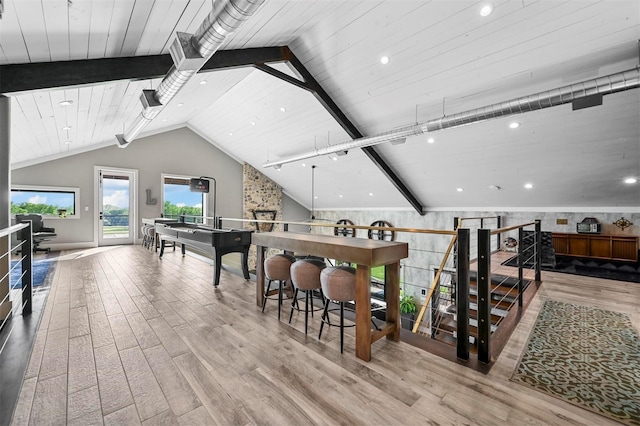 interior space with vaulted ceiling with beams, wood ceiling, and wood finished floors