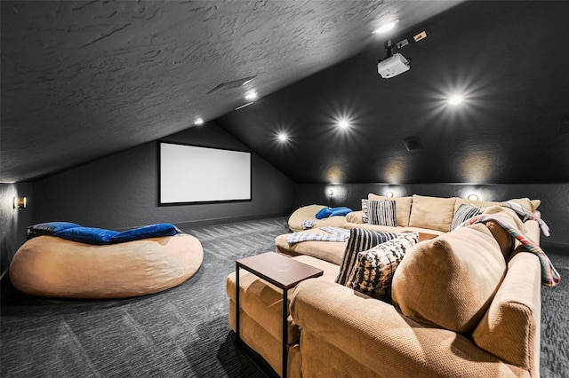 cinema with a textured ceiling, vaulted ceiling, and carpet flooring