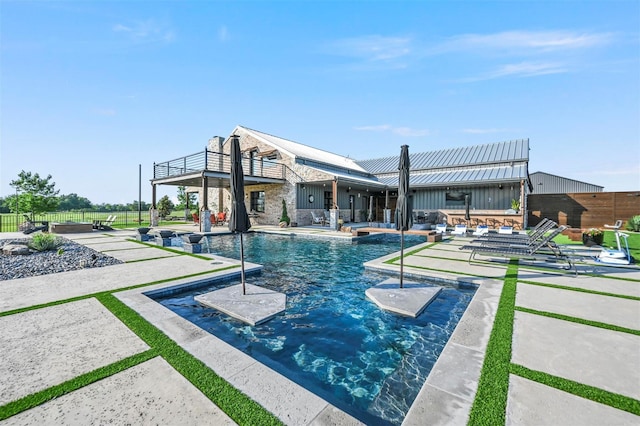 pool featuring fence and a patio