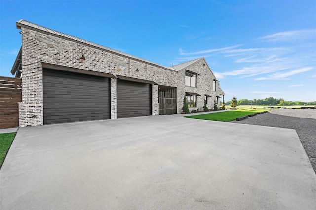 view of front facade with stone siding, driveway, and a front lawn