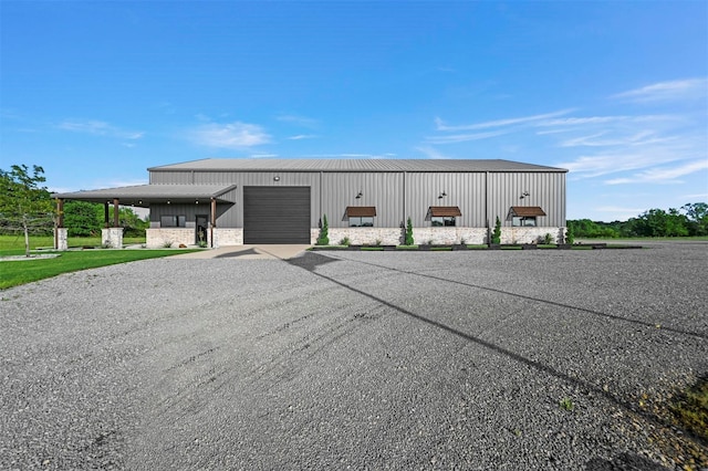 view of building exterior featuring a garage and driveway