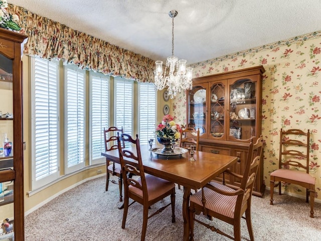 dining space with wallpapered walls, baseboards, a textured ceiling, and light colored carpet