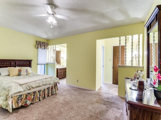 carpeted bedroom with baseboards, a textured ceiling, and ensuite bathroom