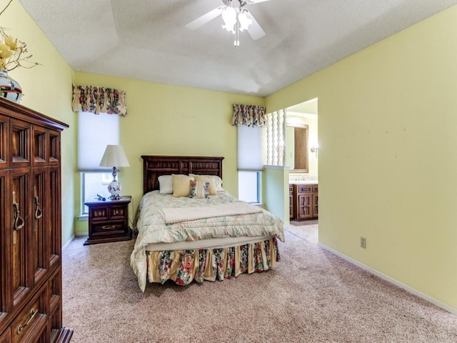 bedroom with carpet flooring, connected bathroom, a textured ceiling, ceiling fan, and baseboards