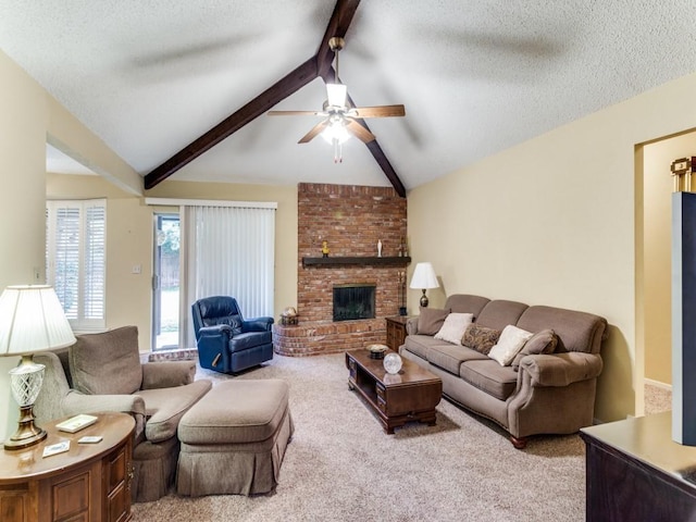 living area with lofted ceiling with beams, ceiling fan, a textured ceiling, carpet flooring, and a fireplace