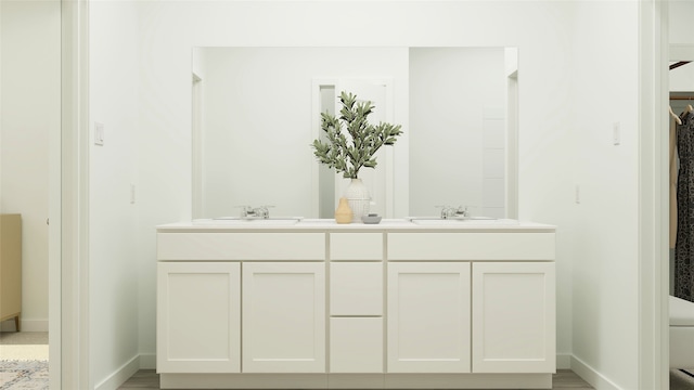 full bathroom with toilet, a sink, baseboards, and double vanity