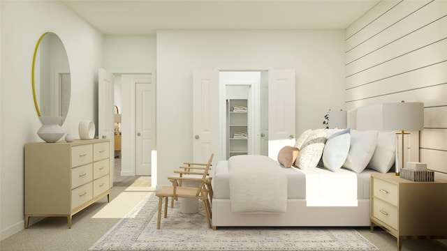 carpeted bedroom featuring a spacious closet and baseboards