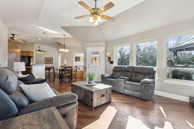 living room featuring baseboards, dark wood finished floors, and vaulted ceiling