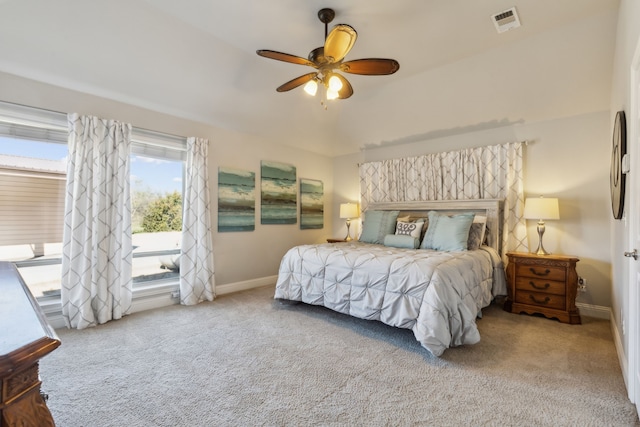 carpeted bedroom with a ceiling fan, baseboards, and visible vents