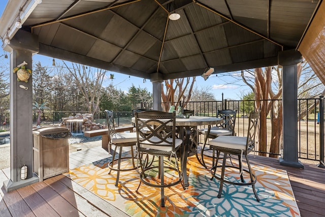 wooden deck with a gazebo and outdoor dining area