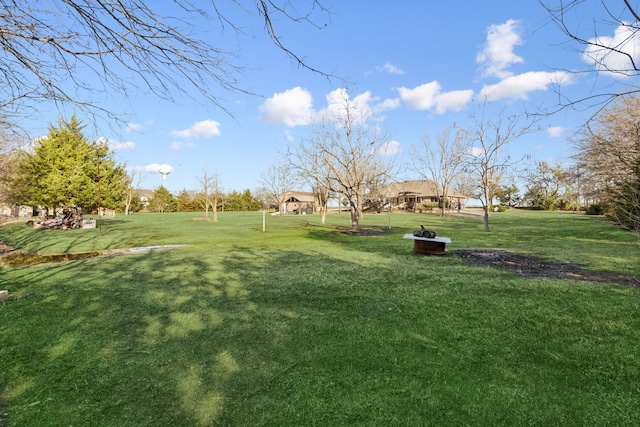 view of yard with a fire pit