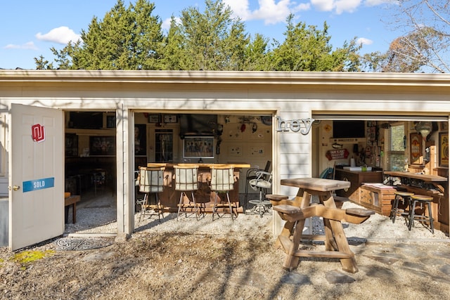 view of patio / terrace with an outbuilding and outdoor dry bar