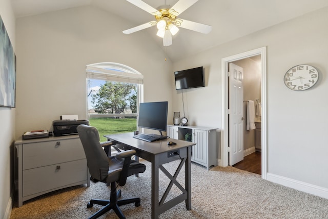 carpeted home office featuring vaulted ceiling, a ceiling fan, and baseboards