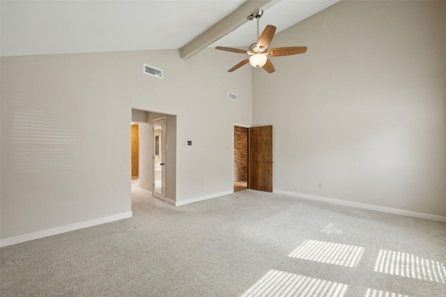 empty room featuring baseboards, beamed ceiling, visible vents, and light colored carpet