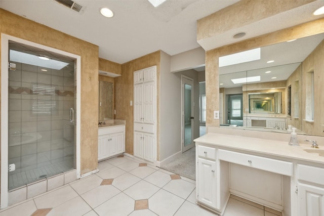 bathroom with recessed lighting, visible vents, baseboards, vanity, and a stall shower