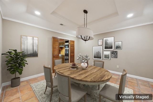 dining area with a raised ceiling, visible vents, and baseboards