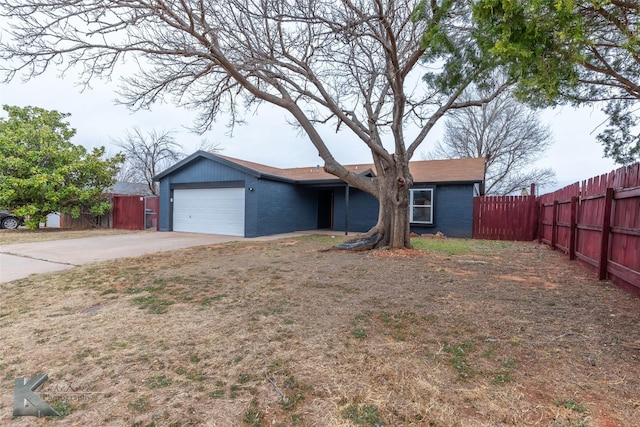 ranch-style home featuring a garage, concrete driveway, brick siding, and fence