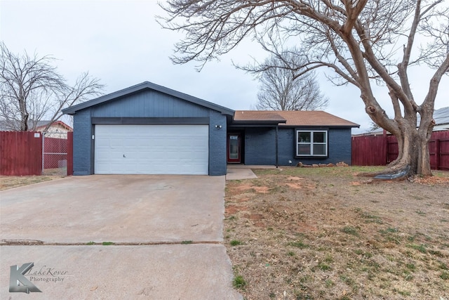 ranch-style house featuring concrete driveway, brick siding, an attached garage, and fence