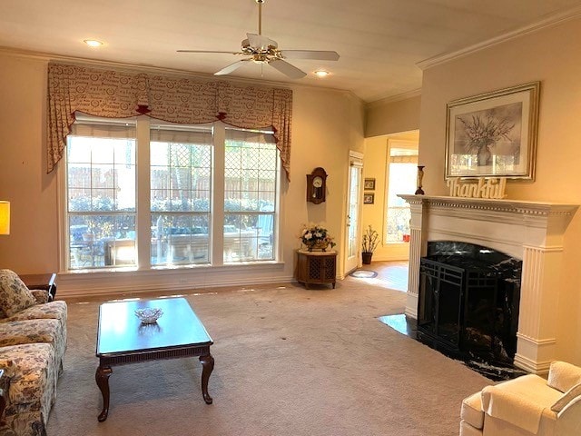 living room with plenty of natural light, crown molding, carpet flooring, and a high end fireplace