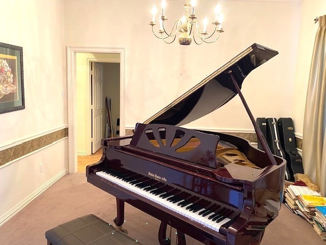 misc room with carpet floors and an inviting chandelier