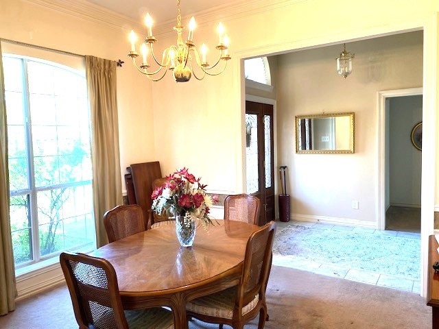 608 Paloma St, Tyler, TX 75703 - dining room featuring carpet, baseboards, an inviting chandelier, and crown molding