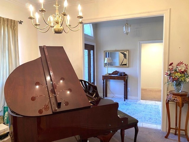 sitting room with a chandelier, carpet, and baseboards