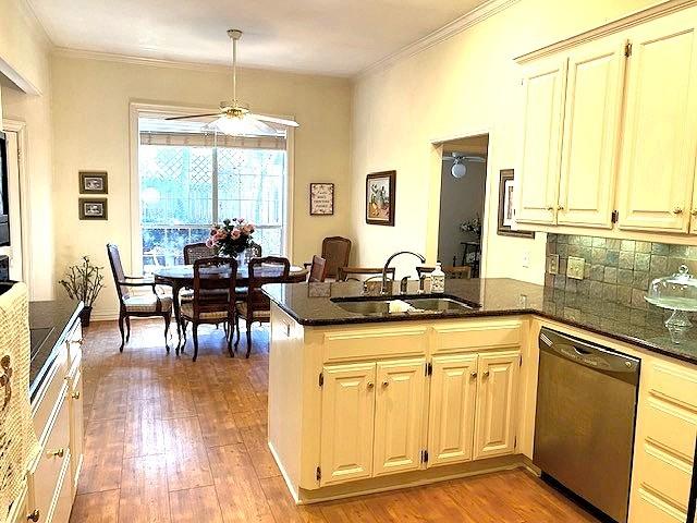 608 Paloma St, Tyler, TX 75703 - kitchen featuring a peninsula, dishwasher, a sink, and ornamental molding