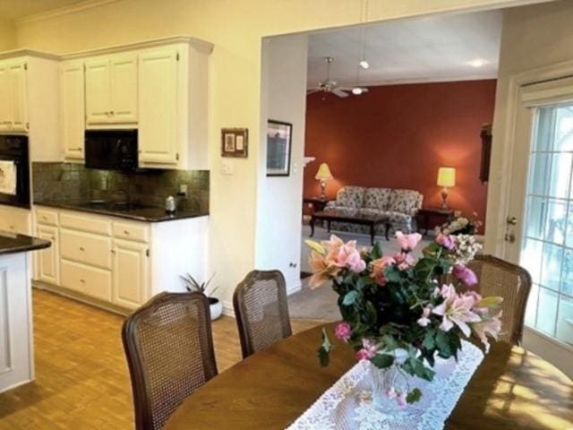 608 Paloma St, Tyler, TX 75703 - dining room with light wood finished floors, crown molding, and ceiling fan