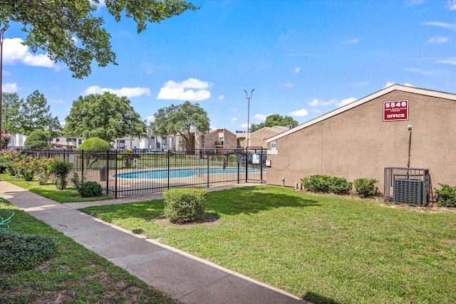 exterior space with a yard, a pool, and fence