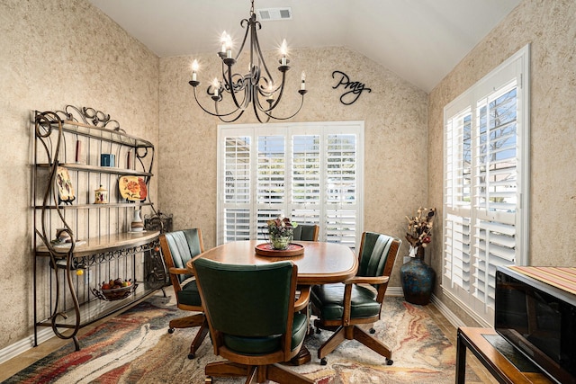 dining space featuring a healthy amount of sunlight, an inviting chandelier, visible vents, and vaulted ceiling