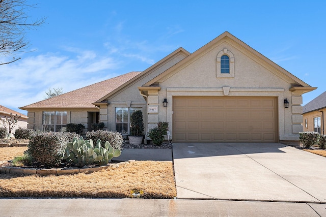 view of front of home with concrete driveway and stucco siding