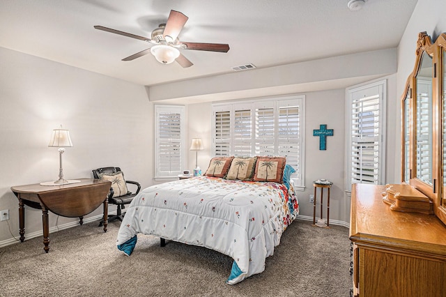 bedroom with carpet floors, baseboards, visible vents, and a ceiling fan