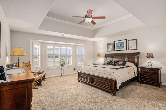 bedroom featuring light colored carpet, a ceiling fan, baseboards, visible vents, and a raised ceiling