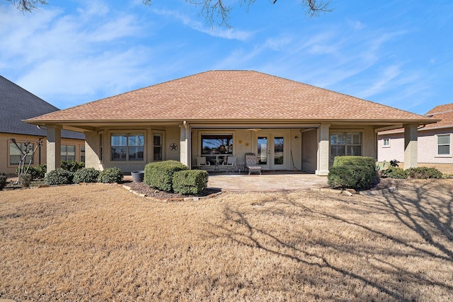 back of house featuring a shingled roof, french doors, a patio, and stucco siding