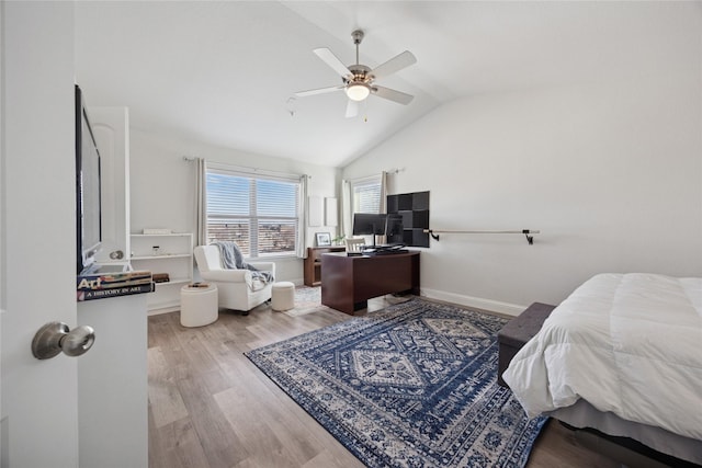 bedroom with lofted ceiling, wood finished floors, a ceiling fan, and baseboards