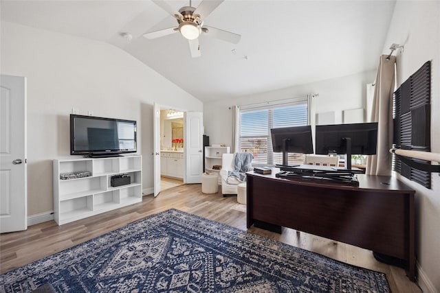 office with baseboards, a ceiling fan, vaulted ceiling, and wood finished floors