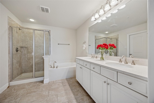 bathroom featuring a bath, a stall shower, a sink, and visible vents