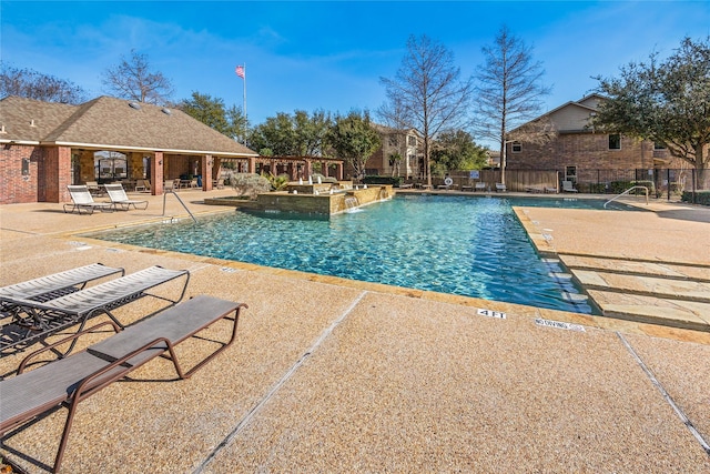 pool with fence and a patio