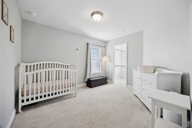 carpeted bedroom featuring baseboards