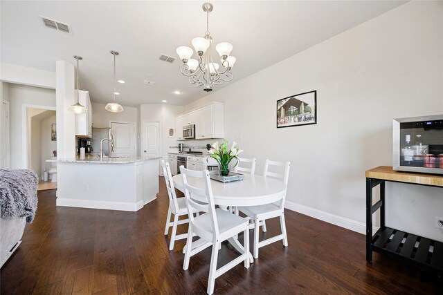 living room featuring a wealth of natural light, a large fireplace, stairway, and wood finished floors