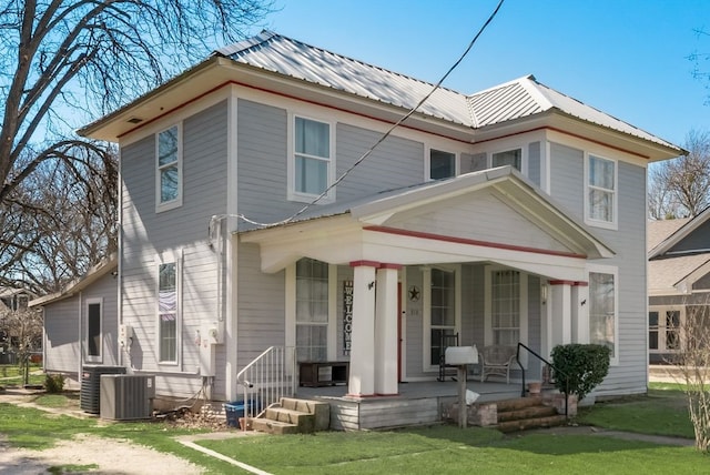 view of front facade with covered porch, metal roof, and central air condition unit